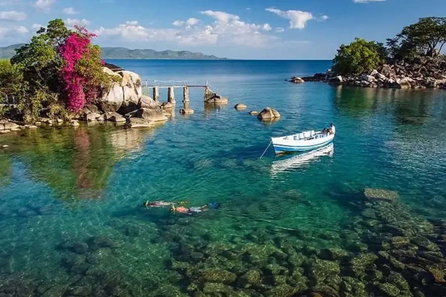 Clear warm shallows and rocky shoreline of Lake Malawi, ideal for family snorkelling and kayaking