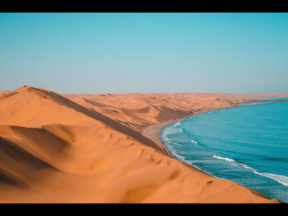 Red dunes of Sossusvlei rising above the desert plains in Namibia