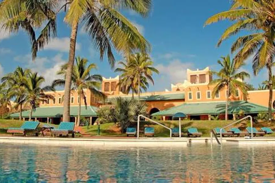 Palm-shaded pool and Portuguese-influenced lodge buildings overlooking Pemba bay on Mozambique's northern coast