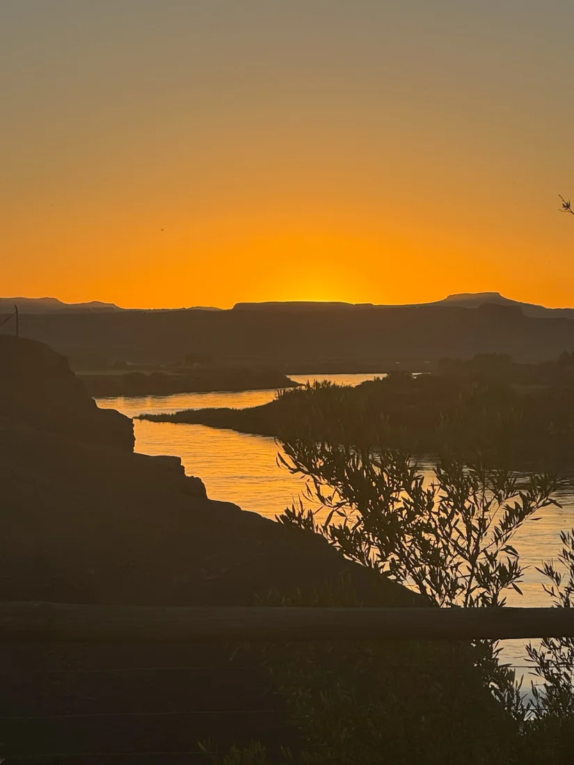 Golden sunset over the Orange River and silhouetted mountains