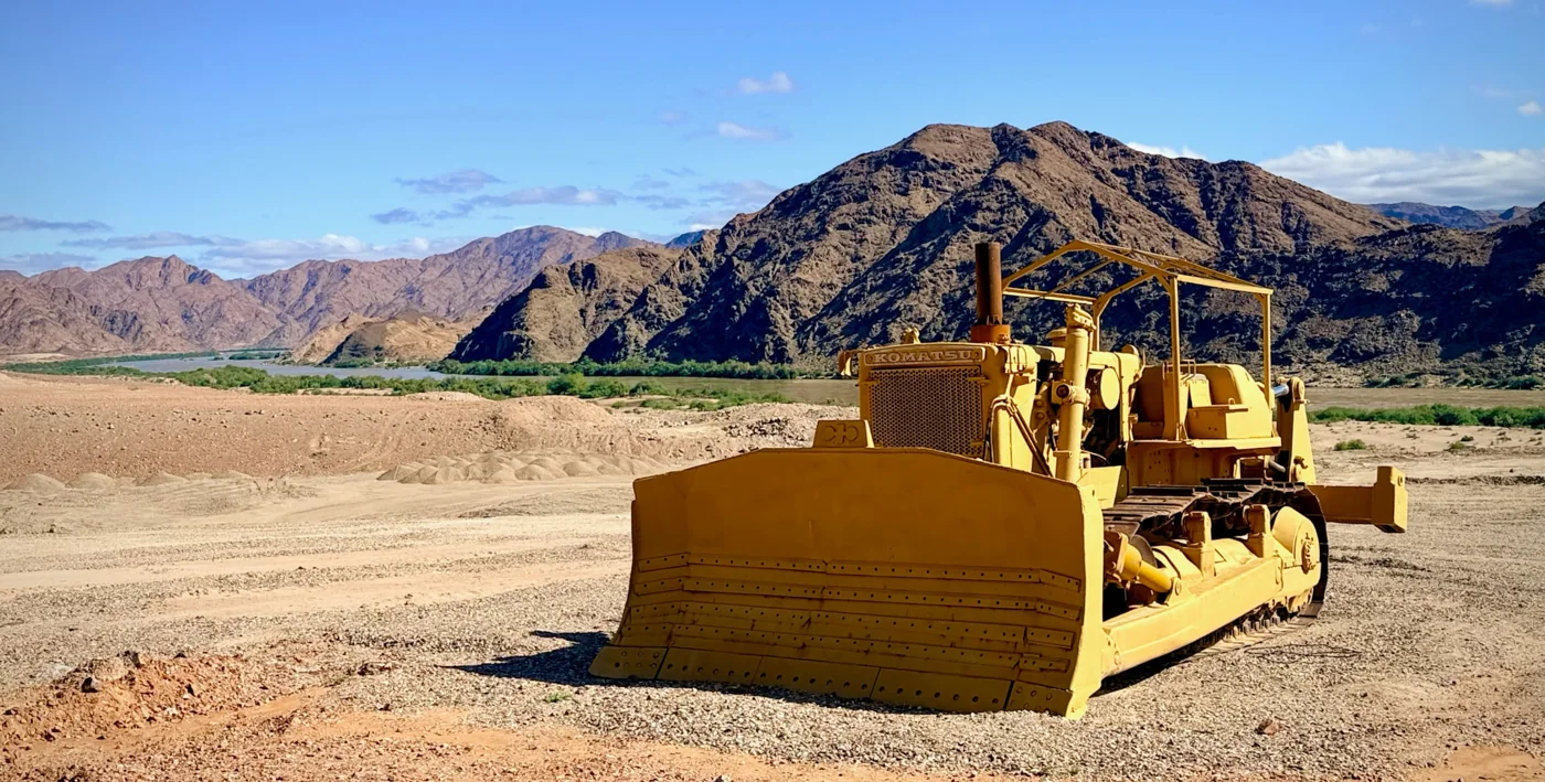 An old yellow bulldozer at an abandoned diamond mine in the desert