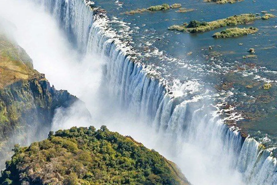 Aerial view of Victoria Falls with the full curtain of water thundering into the Batoka Gorge, Zimbabwe