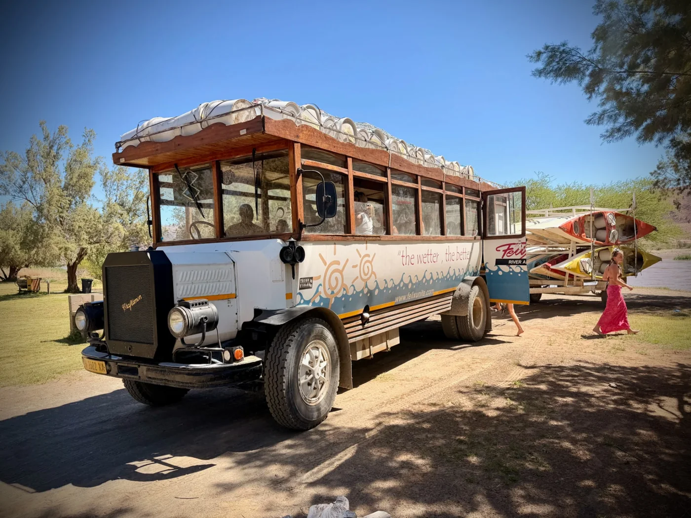 The old Felix Unite bus with a trailer loaded with canoes
