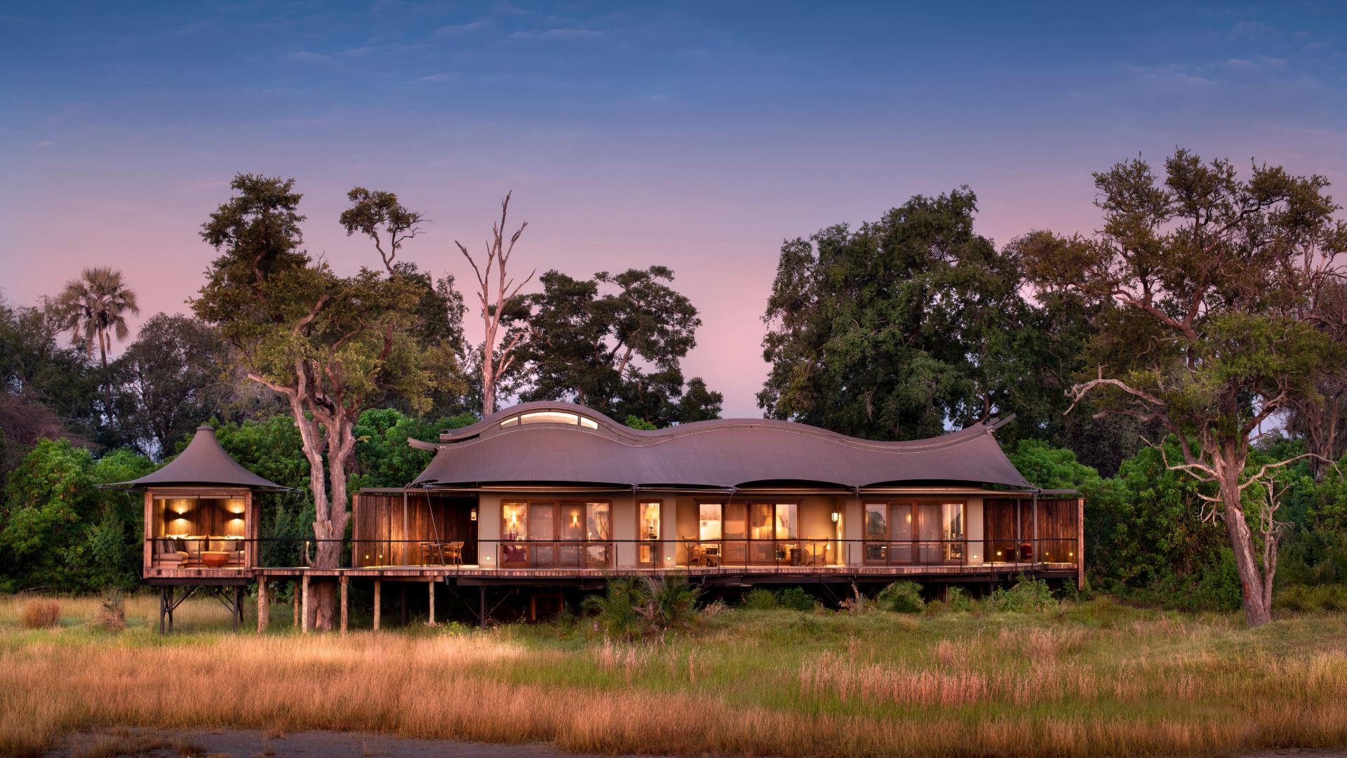 Canvas and timber safari camp raised on decks above the Okavango Delta floodplains