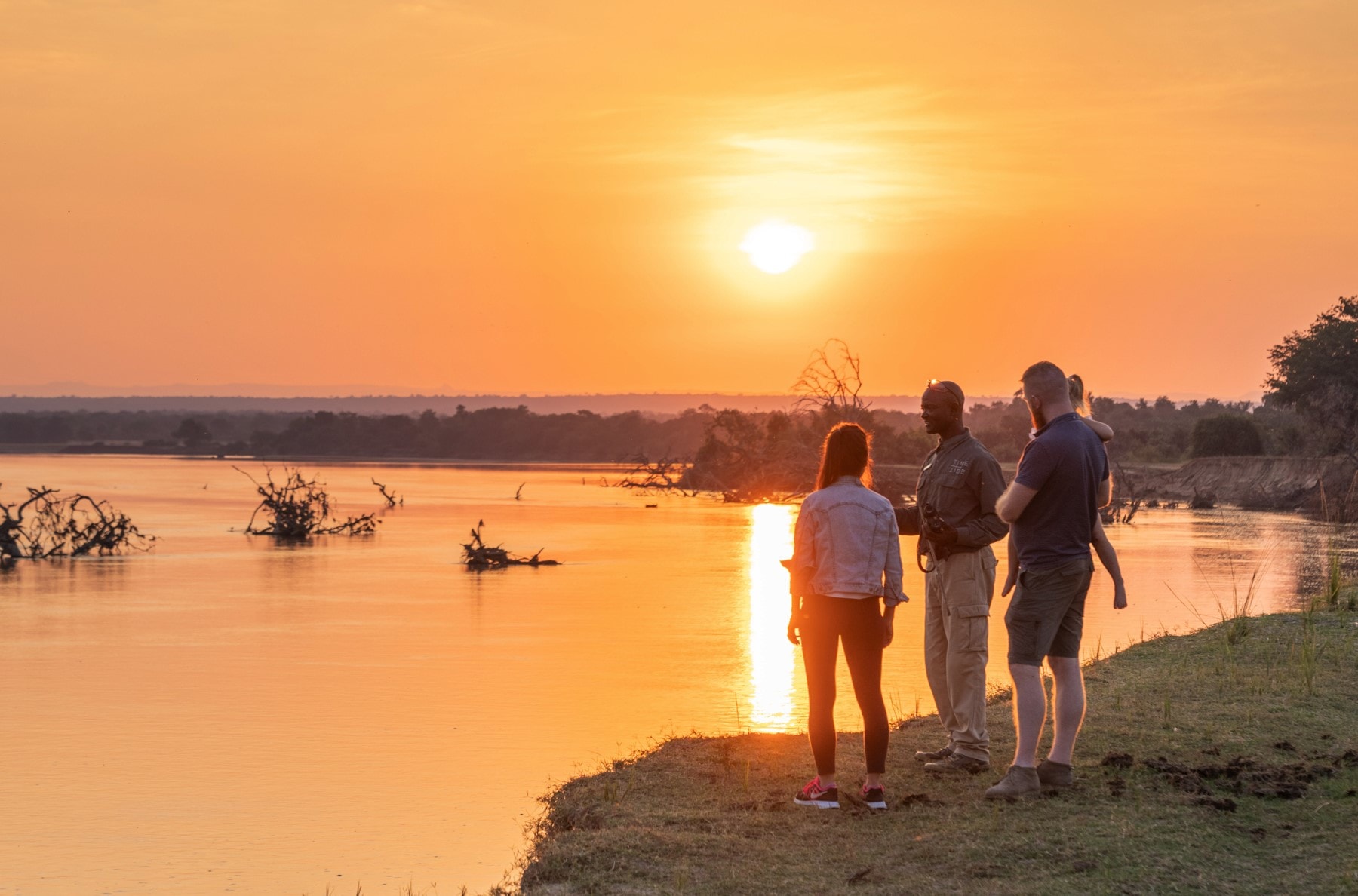 Family at sunset on the Luangwa River, Zambia